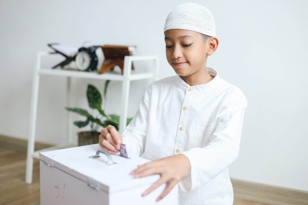 Muslim Boy Giving Money for Charity or Donation